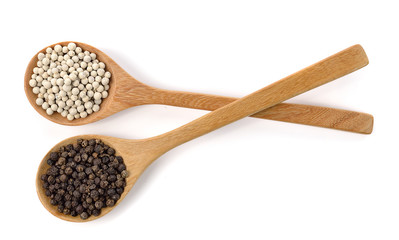 Wooden spoon and peppercorn on white background