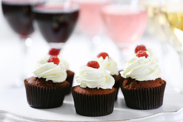 Tasting of wine and chocolate cupcakes, close up