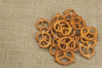 Crispy wheat straw with salt. Pile of pretzel sticks. Entertainment to watch TV.
