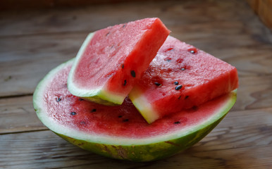 Juicy big red watermelon lying on a wooden table