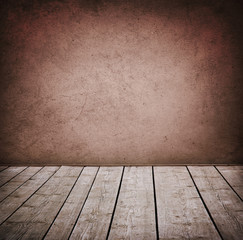 Grunge wall and wood paneled floor, interior of a room.