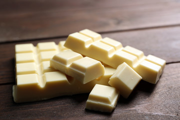 White chocolate pieces on wooden background