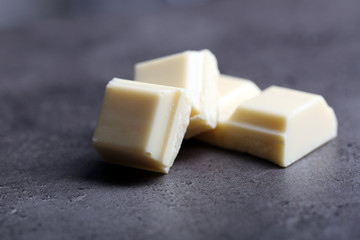 White chocolate pieces on gray background