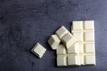 White chocolate pieces on gray background