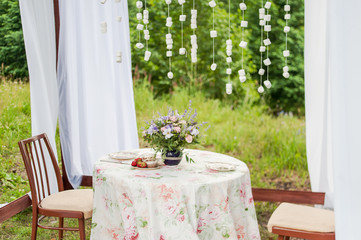 Outdoor gazebo with white curtains. Wedding decorations. 