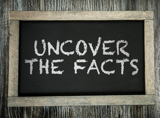 Uncover The Facts written on chalkboard