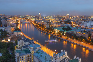 Naklejka premium The evening city of Moscow from a tall building on the embankment of the river