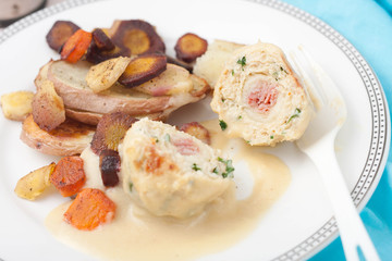 a plate with  meatballs made with ground white meat, ham, cheese