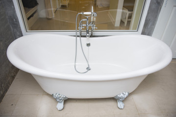 vintage bathtub with faucet and shower in bathroom