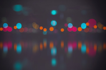 Blurred city lights with bokeh on water