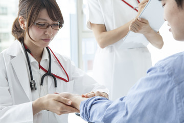The doctor is measuring the pulse