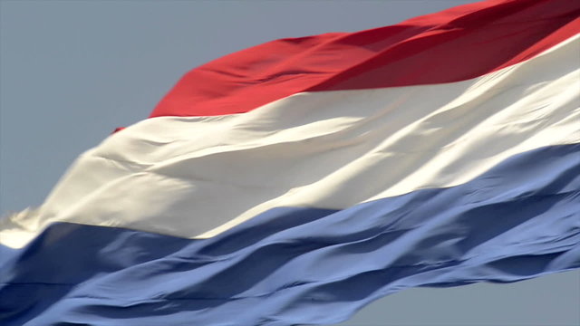 Dutch Flag of The Netherlands with red, white and blue stripes in the wind.