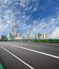 Fototapeta na wymiar Empty road with Shanghai Lujiazui city buildings