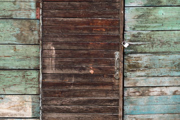 Old wooden barn door with lock. 