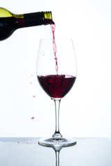 pouring red wine into a glass
