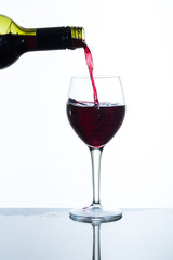 pouring red wine into a glass