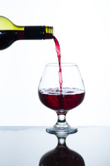 pouring red wine into a glass
