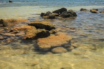Rocks on the coast with small waves coming through