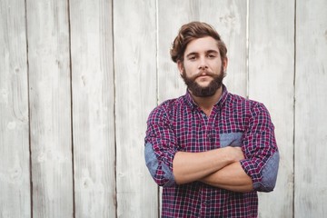 Confident hipster with arms crossed - obrazy, fototapety, plakaty