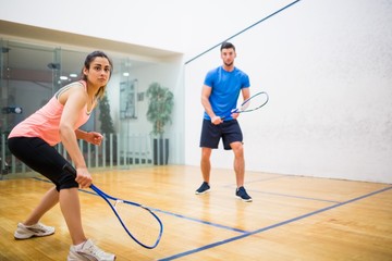 Fototapeta na wymiar Couple play some squash together