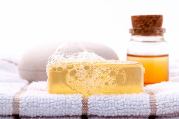 Obraz na płótnie Canvas Herbal spa soap bar on white bath towel with honey isolate on wh