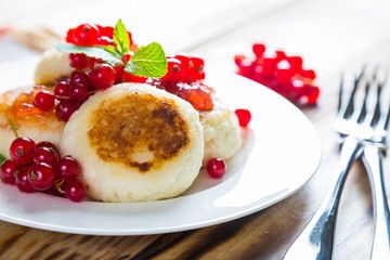 Cottage cheese pancakes with fresh currants, healthy breakfast