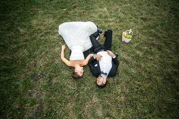 Wedding couple lying on the grass