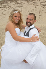 Beautiful couple on the beach in wedding dress