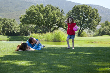 Naklejka premium Happy family is enjoying at park on a weekend day