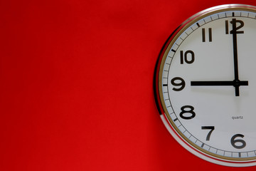 Clock on the red background with space for text