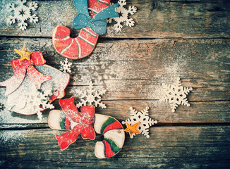 Toned image with Fir Tree Toys Candy Canes, Bell and Snowflakes on Wooden Background