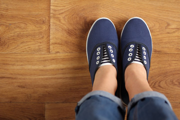 girl in shoes on wooden flooring