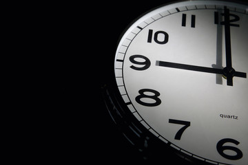 Clock in black background with space for text