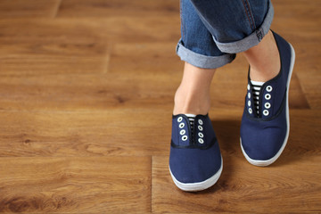 girl in shoes on wooden flooring