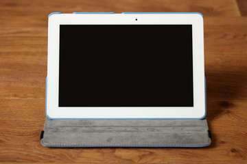 white tablet on wooden background