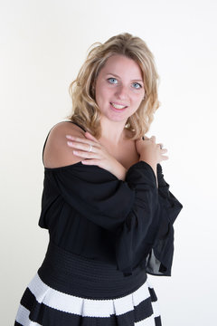 Blond young woman with a black and white dress