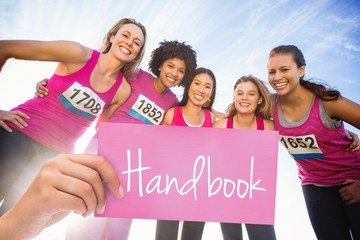 Handbook pink sign against five smiling runners