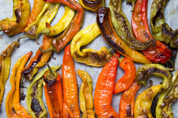 Colorful peppers baked on white backing paper