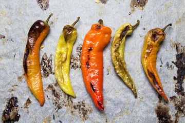 Colorful peppers baked on white backing paper