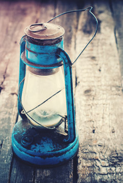 Vintage Dirty Blue Oil Lamp on Wooden Background