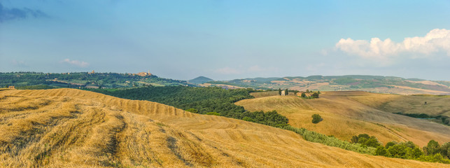 Tuscany landscape with famous chapel, rolling hills and the town of Pienza at sunset, Val d'Orcia, Italy