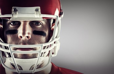 Composite image of american football player looking at camera