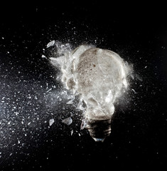 explosion glass bulb traditional black background. fragility time creativity