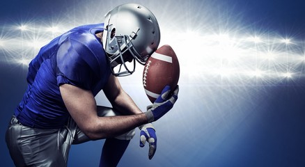 Composite image of upset american football player with ball