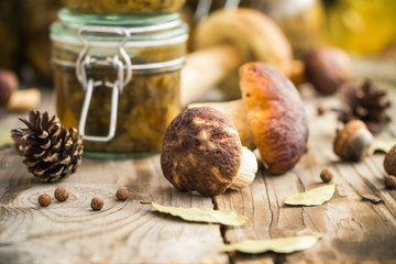 Marinated mushrooms jars wooden table