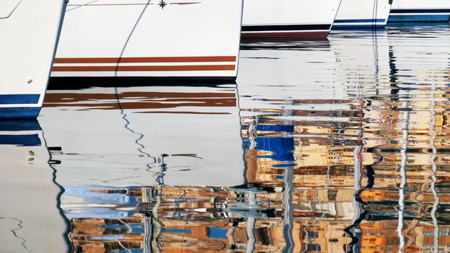 Reflection of yachts and maltese architecture in water of malta bay
