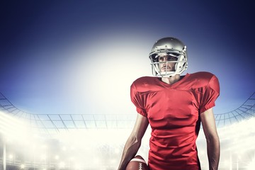 American football player holding ball