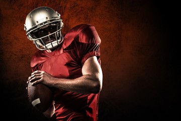 American football player holding ball