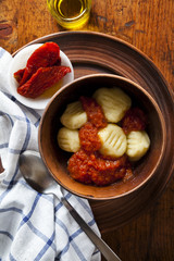 Italian gnocchi with tomato and basil. rustic stile
