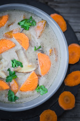 Warm meal mushroom soup carrots parsley wooden table